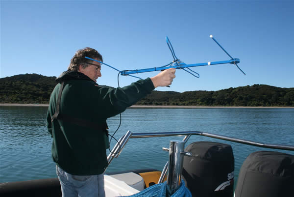 Direction-finding - Mike Lee monitoring bellbirds from the sea off Whakanewha Regional Park Direction-finding - Mike Lee monitoring bellbirds from the sea off Whakanewha Regional Park