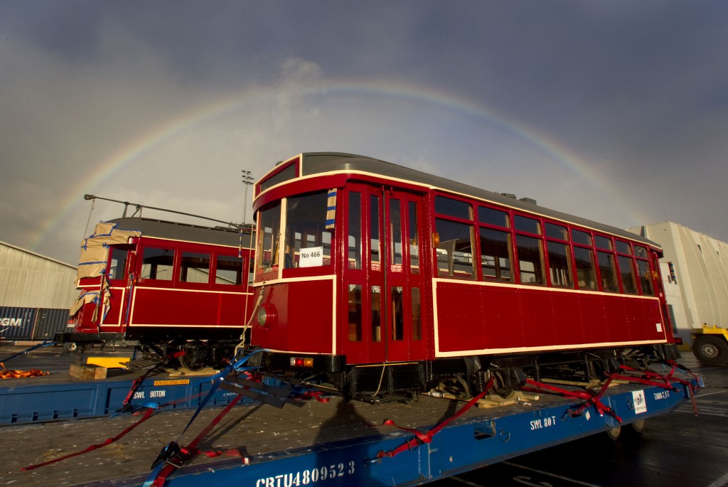 Heritage trams arrive in Auckland - watched over by a rainbow